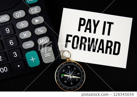 Pay It Forward text with compass and calculator on black background 128343034