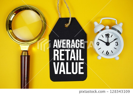 Average Retail Value text on price tag with magnifying glass and alarm clock on yellow background 128343109