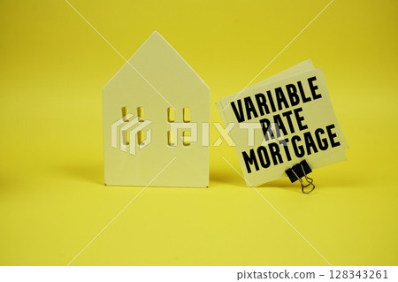 Variable Rate Mortgage text with house model on yellow background Variable Rate Mortgage text with house model on yellow background 128343261