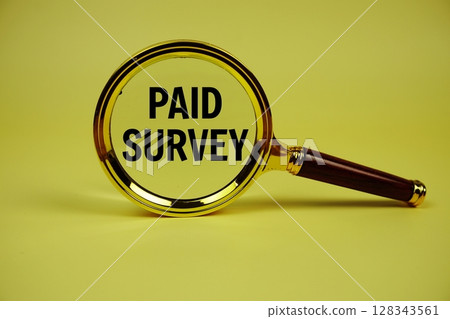 Paid Survey text with magnifying glass on yellow background 128343561
