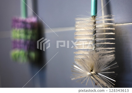 Bottle Brush Is Hung On The Wall In The Bathroom, Background for advertising and wallpaper in tool and cleaning scene 128343613
