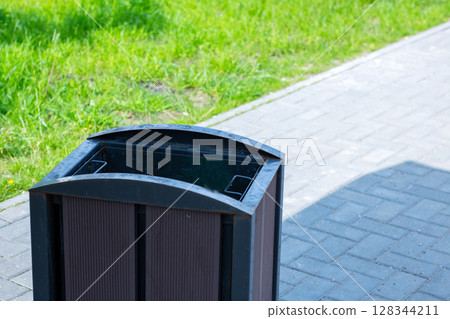 Modern Outdoor Trash Bin in Park Environment, Boosting Public Cleanliness and Aesthetics Modern Outdoor Trash Bin in Park Environment, Boosting Public Cleanliness and Aesthetics 128344211