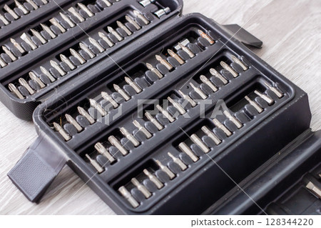 This is a collection of screwdriver bits organized within a plastic case This is a collection of screwdriver bits organized within a plastic case 128344220