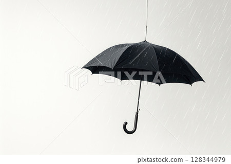 A lonely umbrella hangs in the rainy air. Space for text. A lonely umbrella hangs in the rainy air. Space for text. 128344979