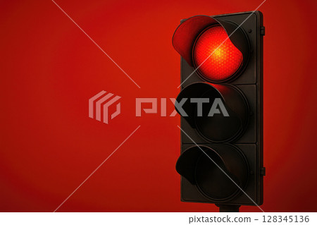 Red traffic light on a bright background. Space for text. 128345136