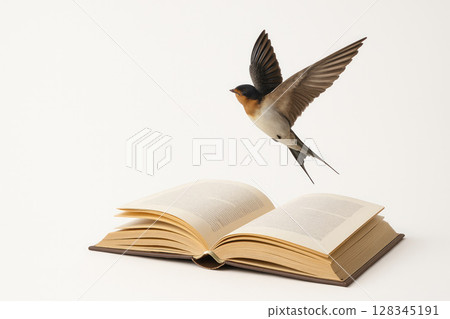 A swallow flies over an open book. Space for text. 128345191