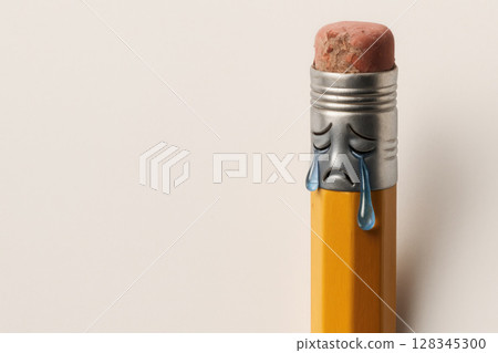 Pencil crying with his face on an eraser. Space for text. 128345300