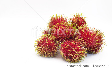 Close-up of ripe rambutan fruits with vibrant red skin and soft green spines, isolated on a white background. Ideal for use in tropical fruit promotions Close-up of ripe rambutan fruits with vibrant red skin and soft green spines, isolated on a white background. Ideal for use in tropical fruit promotions 128345598