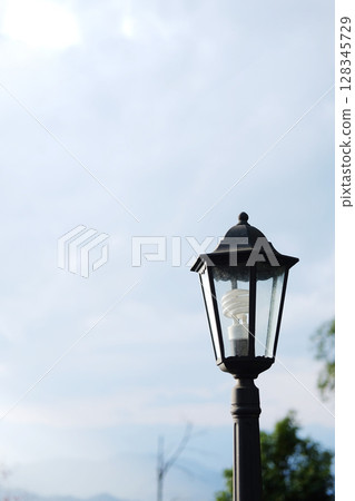 Beautiful classic and vintage black iron street lamp with blue sky. Copy space Beautiful classic and vintage black iron street lamp with blue sky. Copy space 128345729