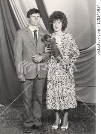 Vintage portrait of a middle-aged bride and groom. Retro wedding photo from 1985. 128345934