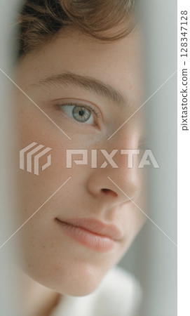 Model engages in daily skincare with peptide serum, reflecting a calm morning atmosphere Model engages in daily skincare with peptide serum, reflecting a calm morning atmosphere 128347128