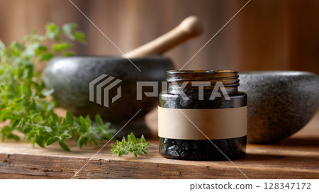 Herbal remedy jar with shilajit and mortar on wooden table surrounded by fresh herbs and natural elements 128347172