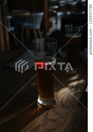 Glasses of light beer with at bar. 128347786