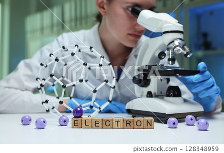 A Scientist Engaged in Observing Electron Microscopy While Utilizing a Molecular Model A Scientist Engaged in Observing Electron Microscopy While Utilizing a Molecular Model 128348959