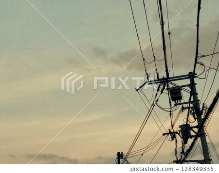 Silhouette of electric wires at sunset 128349335