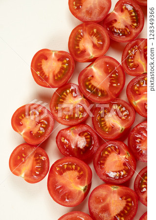 Small ripe tomatoes cut into halves macro top view Small ripe tomatoes cut into halves macro top view 128349366