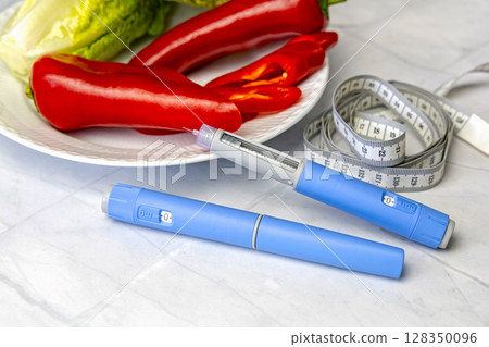 Original Danish Ozempic Insulin injection pen for diabetics and plate with vegetables. Original Danish Ozempic Insulin injection pen for diabetics and plate with vegetables. 128350096