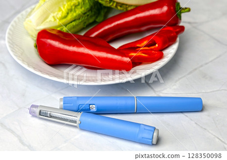 Original Danish Ozempic Insulin injection pen for diabetics and plate with vegetables. 128350098