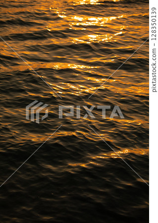 The sea dyed by the setting sun 128350139