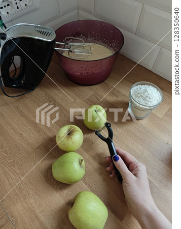Preparing a delicious apple dessert in a cozy kitchen 128350640