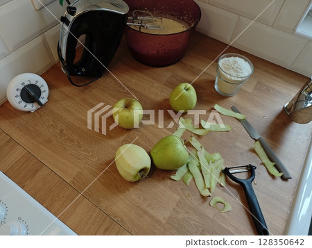 Preparation for a delightful pie with fresh apples on a cozy kitchen countertop 128350642