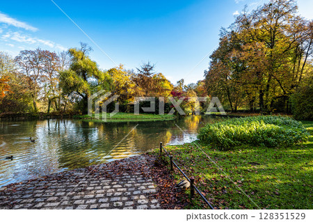 Golden autumn view in famous Munich relax place - Englischer Garten. Munich, Bavaria, Germany Golden autumn view in famous Munich relax place - Englischer Garten. Munich, Bavaria, Germany 128351529