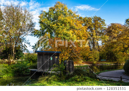 Golden autumn view in famous Munich relax place - Englischer Garten. Munich, Bavaria, Germany Golden autumn view in famous Munich relax place - Englischer Garten. Munich, Bavaria, Germany 128351531