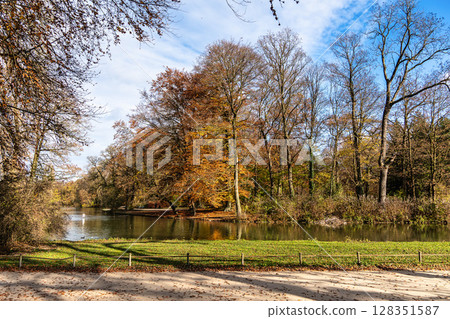 Golden autumn view in famous Munich relax place - Englischer Garten. Munich, Bavaria, Germany Golden autumn view in famous Munich relax place - Englischer Garten. Munich, Bavaria, Germany 128351587