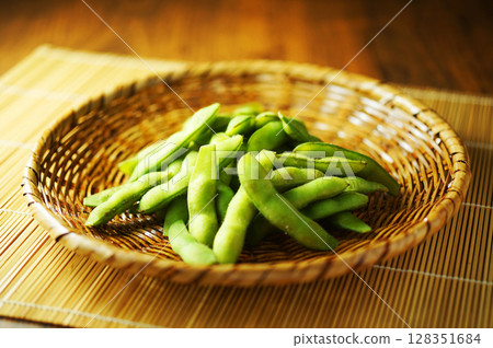 Boiled edamame beans served in a mesh strainer Boiled edamame beans served in a mesh strainer 128351684