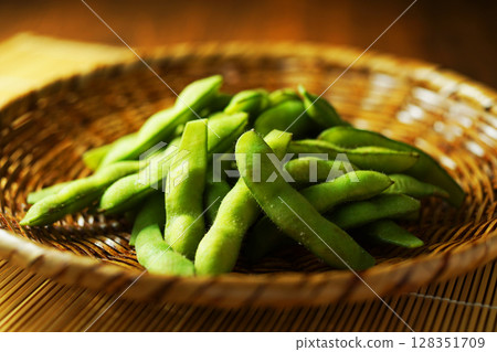 Boiled edamame beans served in a mesh strainer Boiled edamame beans served in a mesh strainer 128351709