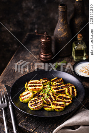 Grilled zucchini with sauce, vegan dish Grilled zucchini with sauce, vegan dish 128351850