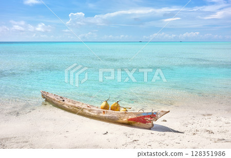 Coconuts in a wooden boat off the beach of Timba Timba Island, summer vacation concept, Borneo, Malaysia. 128351986