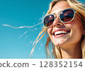 Close-up portrait of a happy smiling blonde woman in sunglasses on a sunny day. 128352154