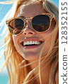 Close-up portrait of a happy smiling blonde woman in sunglasses on a sunny day. 128352155