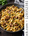 Gourmet pasta dish with savory beef stew, garnished with herbs. 128352381