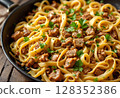 Gourmet pasta dish with savory beef stew, garnished with herbs. 128352386