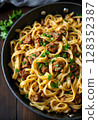 Gourmet pasta dish with savory beef stew, garnished with herbs. 128352387