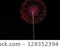 Large fireworks blooming in the summer night sky 128352394