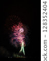 Large fireworks blooming in the summer night sky 128352404