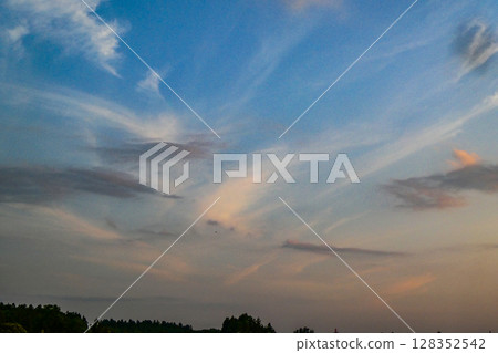 Early summer evening scene with flying clouds Early summer evening scene with flying clouds 128352542