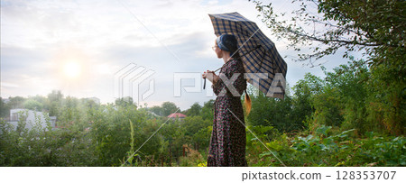 Young girl with big umbrella 128353707
