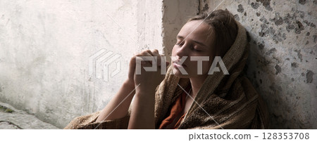 Poor young girl prayint to God 128353708