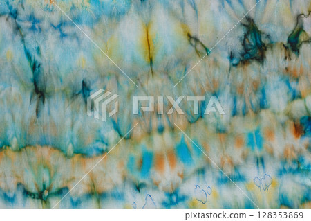 abstract pattern on silk fabric texture in blue, yellow, green colors 128353869