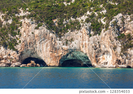 Grotta del Bue Marino sea caves in limestone cliffs on the eastern Sardinian coast with turquoise Mediterranean water Grotta del Bue Marino sea caves in limestone cliffs on the eastern Sardinian coast with turquoise Mediterranean water 128354033