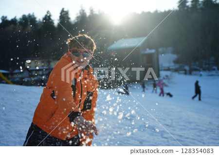 Joyful Snowball Throw in Winter Landscape 128354083