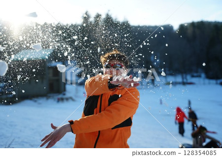 Teen Enjoys Snowball Fight in Winter Wonderland 128354085