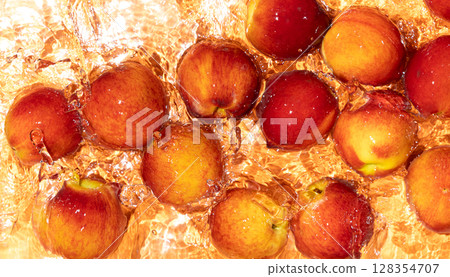 Fruity summer background whole peaches in a water top view. 128354707