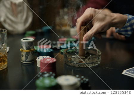Man Putting Out Cigar During Intense Poker Game Man Putting Out Cigar During Intense Poker Game 128355348