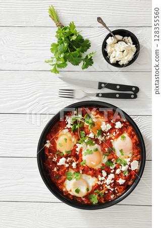 shakshuka, eggs poached in tomato vegetable sauce shakshuka, eggs poached in tomato vegetable sauce 128355560