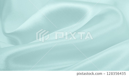 Smooth elegant blue silk or satin luxury cloth texture as abstract background. Luxurious background design Smooth elegant blue silk or satin luxury cloth texture as abstract background. Luxurious background design 128356435